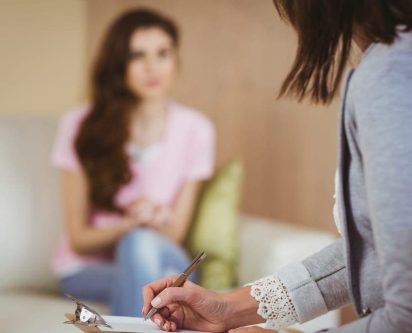 Hypnotherapy Melbourne Counselling Services - Counsellor taking notes about patients issues.
